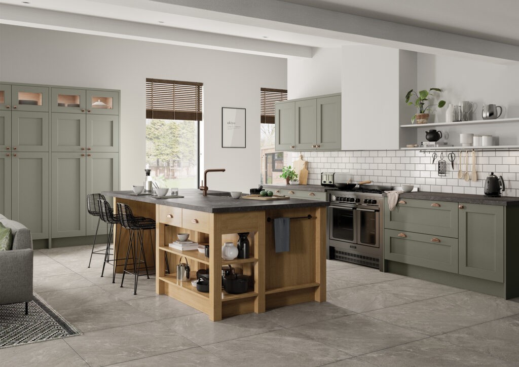 Sage green shaker kitchen with oak island and copper tap in open-plan living space