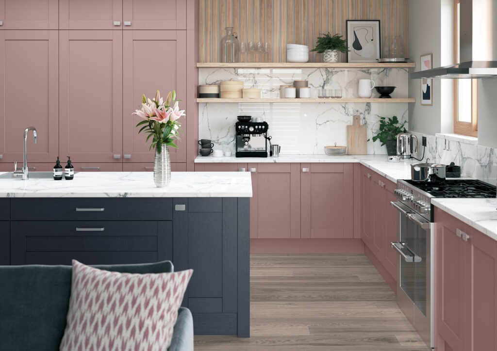 Pink shaker kitchen with navy island and white marble worktops