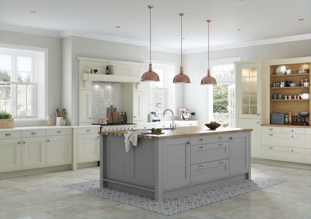 Cream shaker kitchen with grey island, oak worktop and copper pendant lights